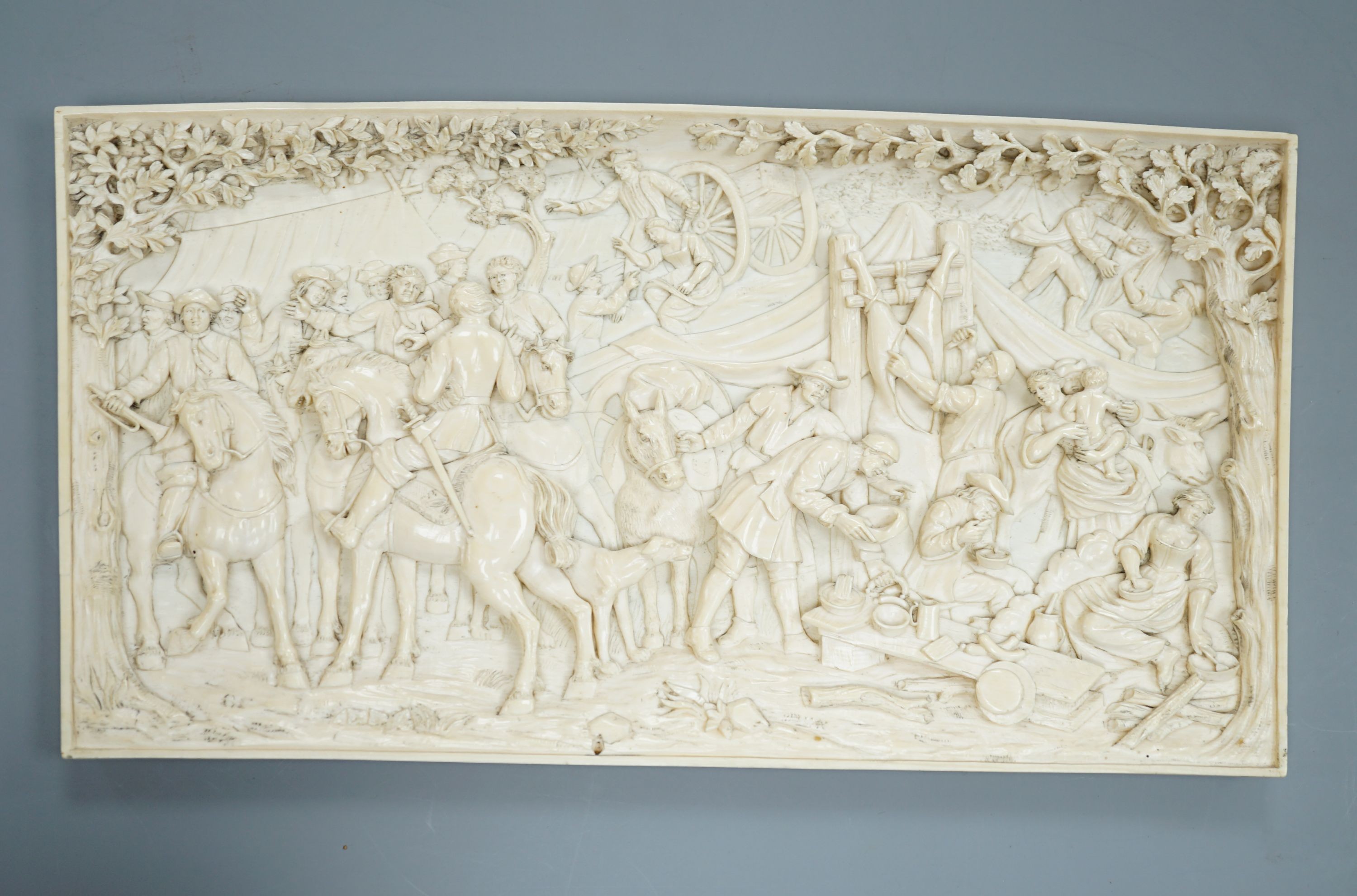 An 18th century Flemish carved ivory plaque (initials OF?) with scenes of hunters and village life, 15 x 28cm